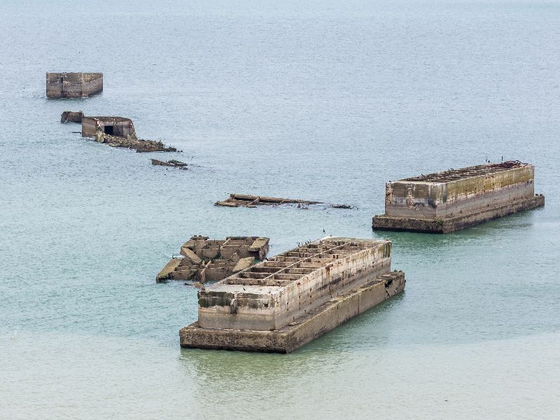 The remains of the Mulberry Harbour are still visible just off the coast at Arromanches