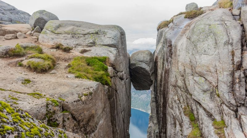The Kjeragbolten, a boulder wedged between two steep cliffs. The Kjeragbolten, a boulder wedged between two steep cliffs.