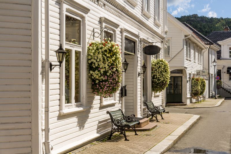 The old wooden houses of Flekkefjord are decorated with flower The old wooden houses of Flekkefjord are decorated with flower